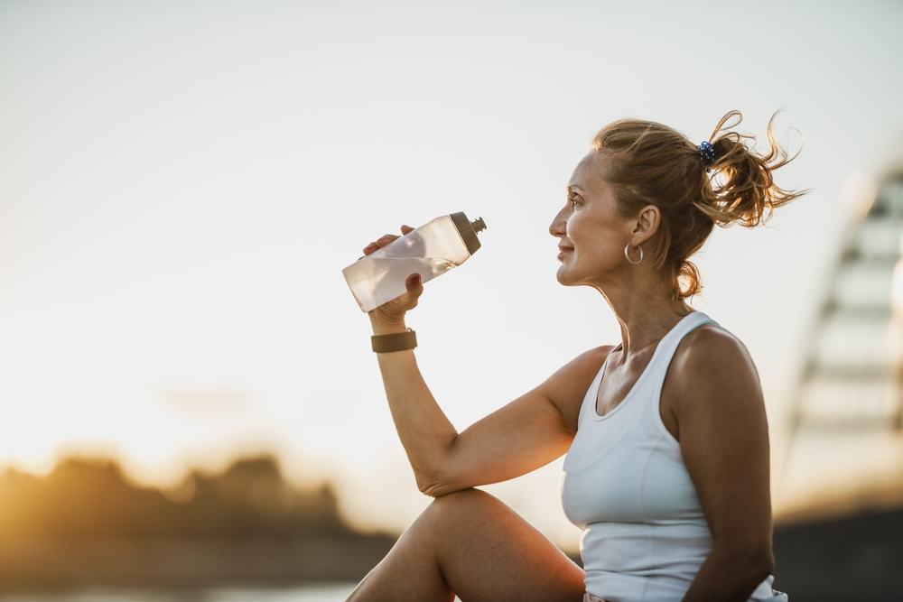 woman drinking water outside