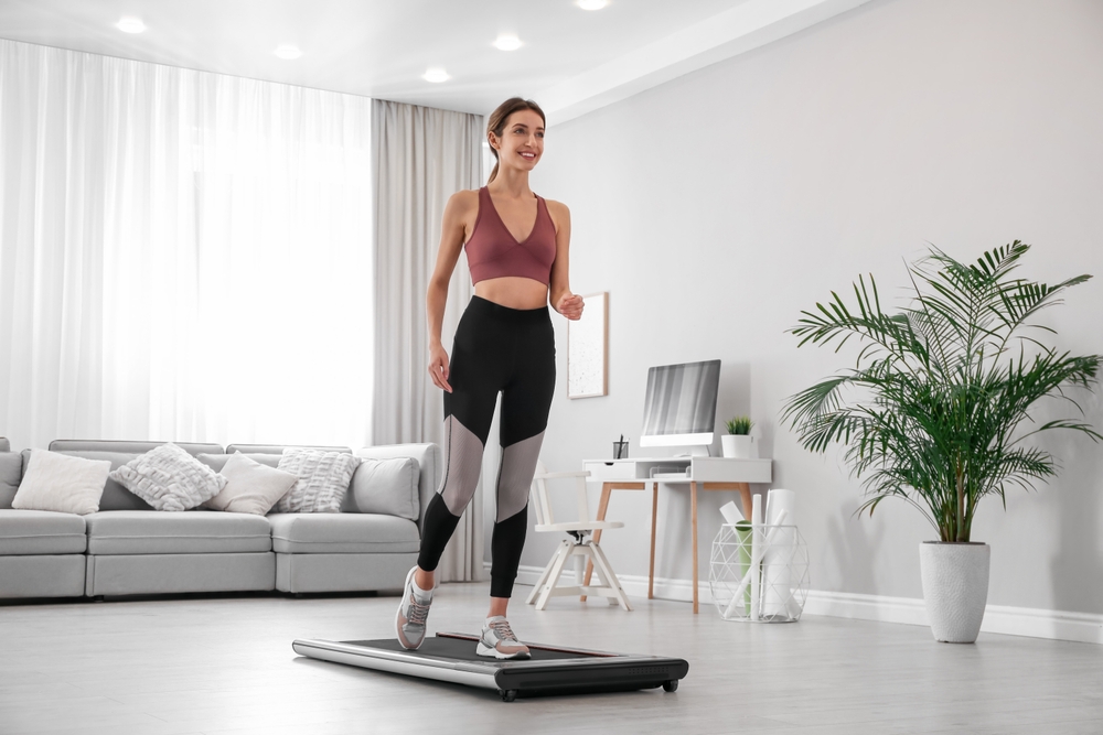 woman walking on walking pad indoors