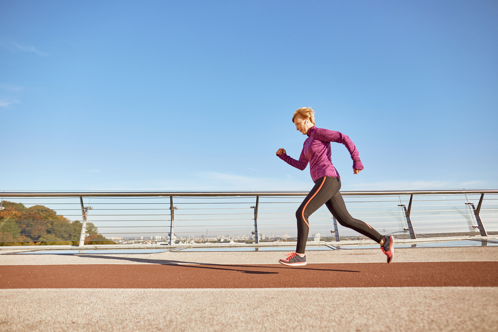 woman running outside motivated for weight loss