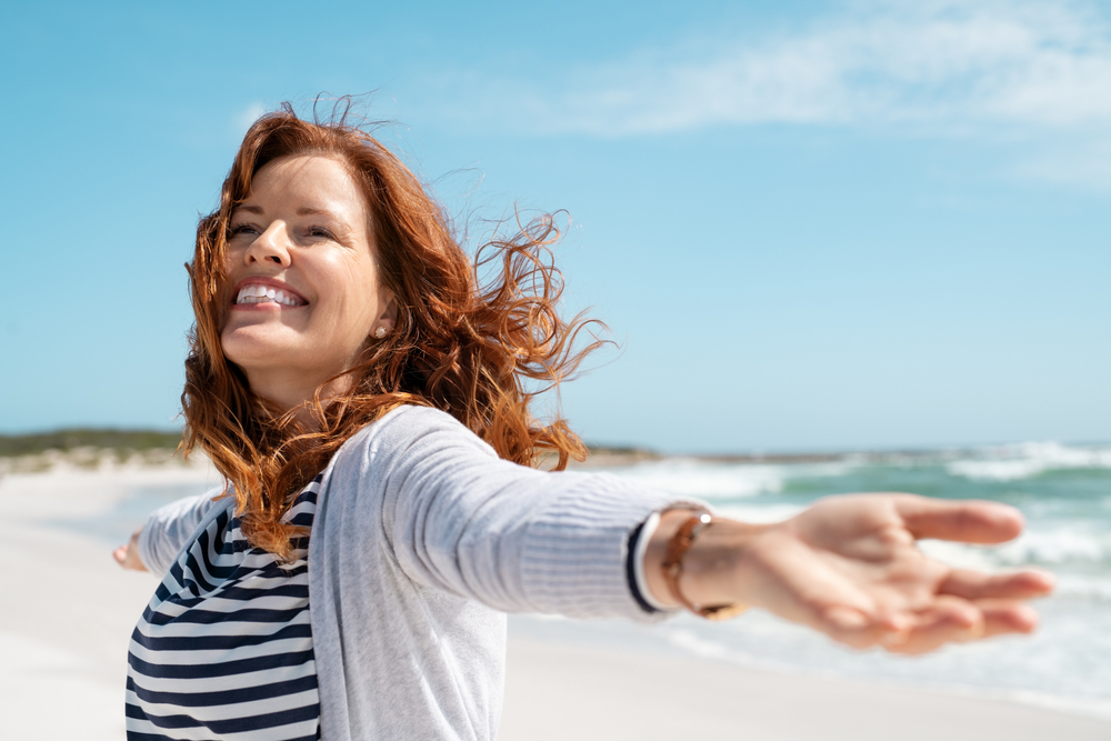 happy healthy woman smiling in sun