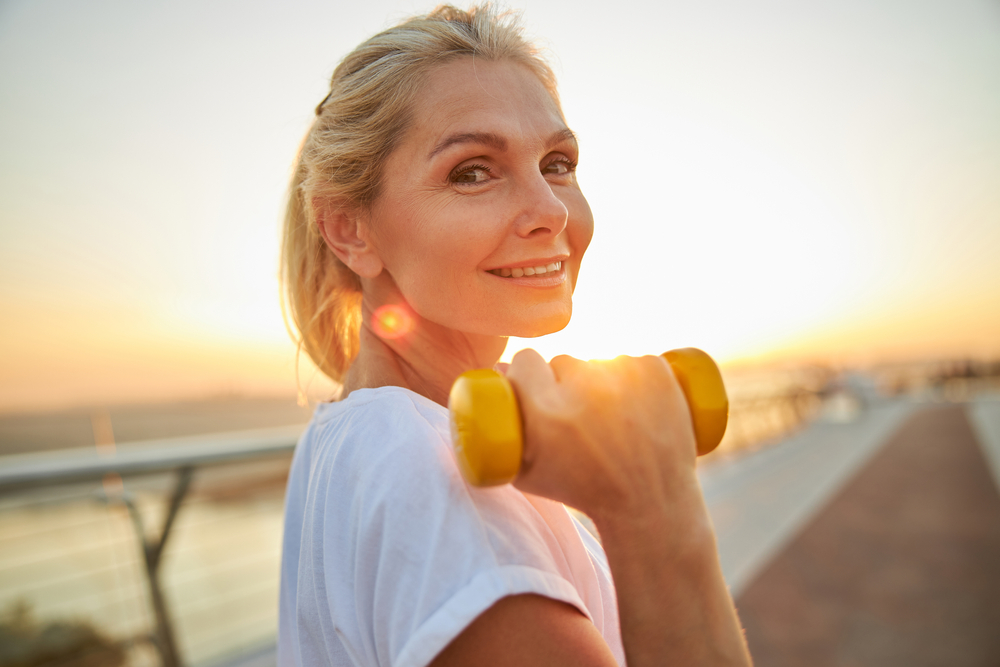 happy woman strength training outside