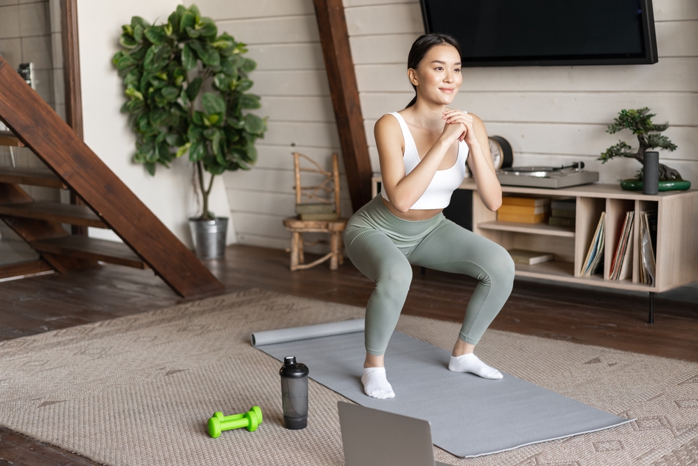 woman doing plie squat for bubble butt exercises indoors