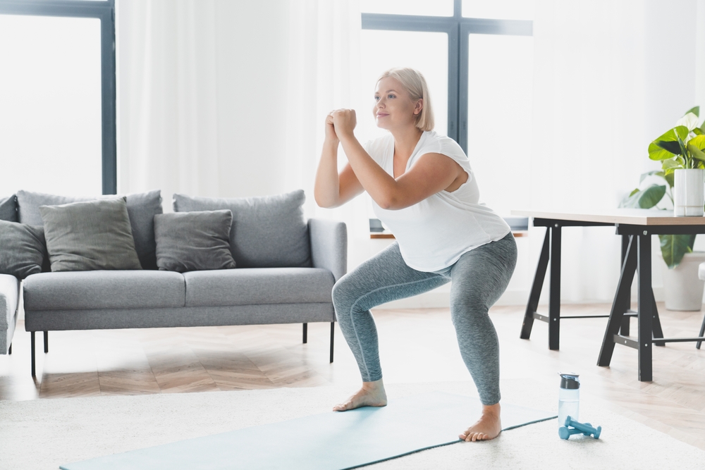 woman doing squat exercises indoors