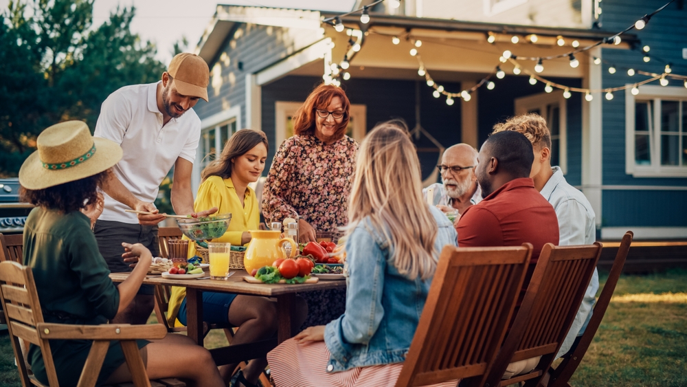 A group of friends eating dinner outdoors.