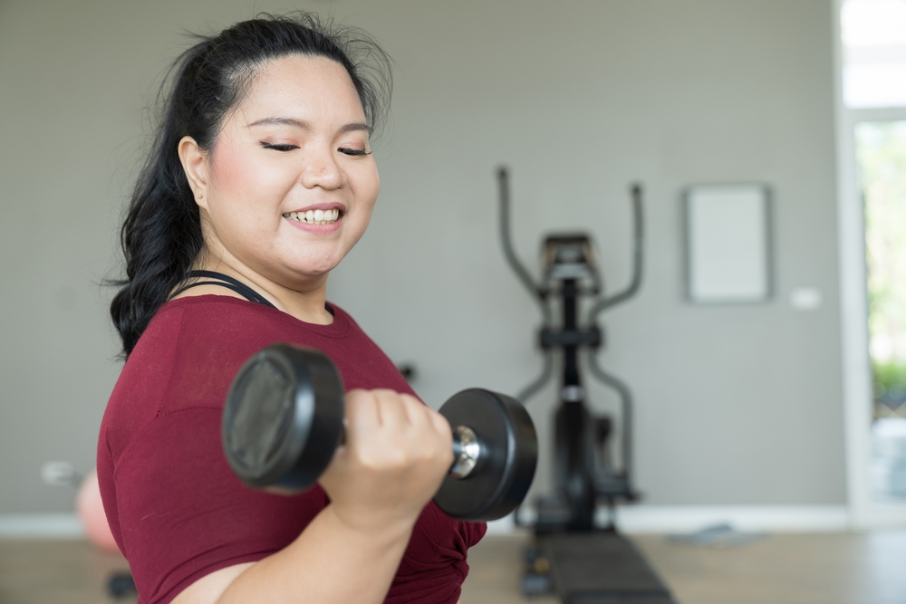 Close up of woman lifting a dumbbell.