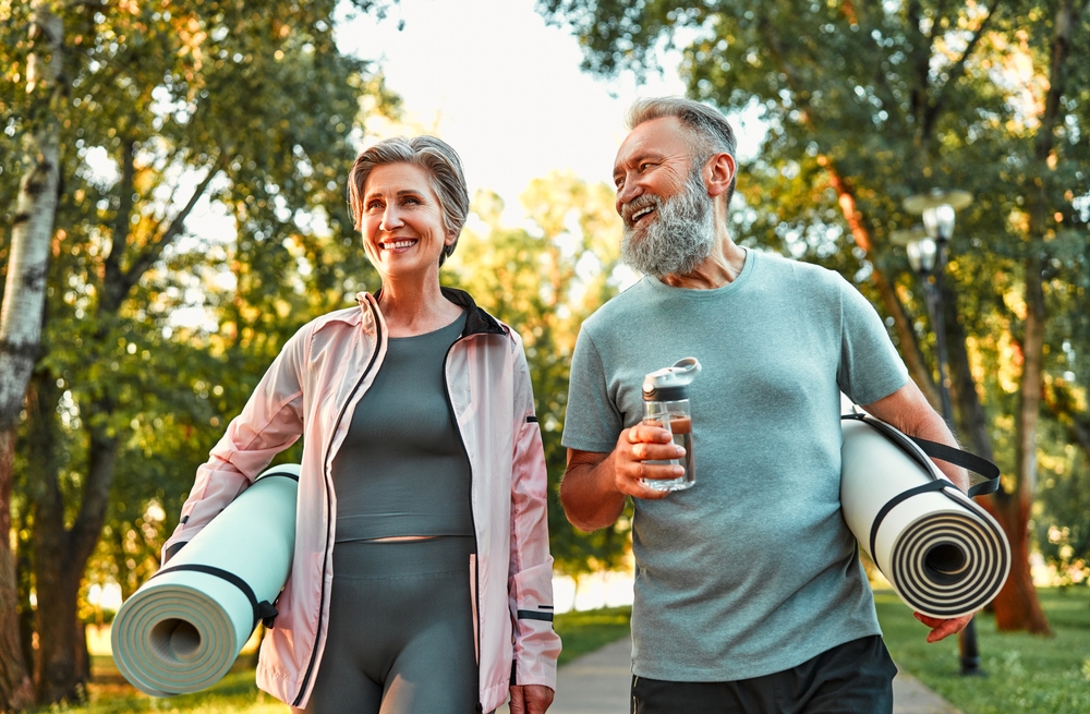 happy couple walking outside exercising