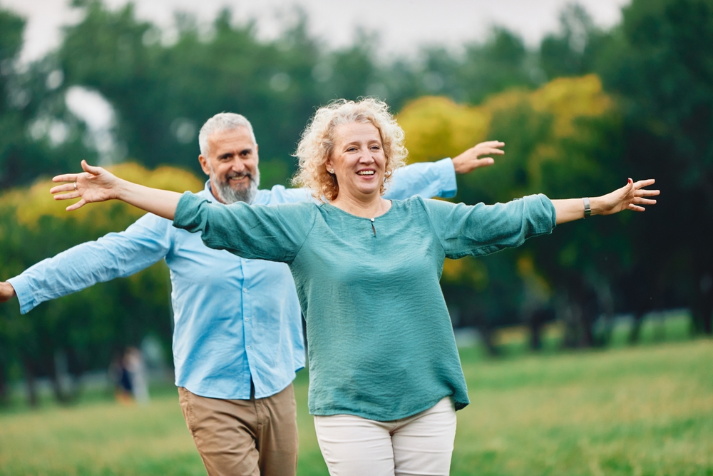 couple practicing balance exercises outside