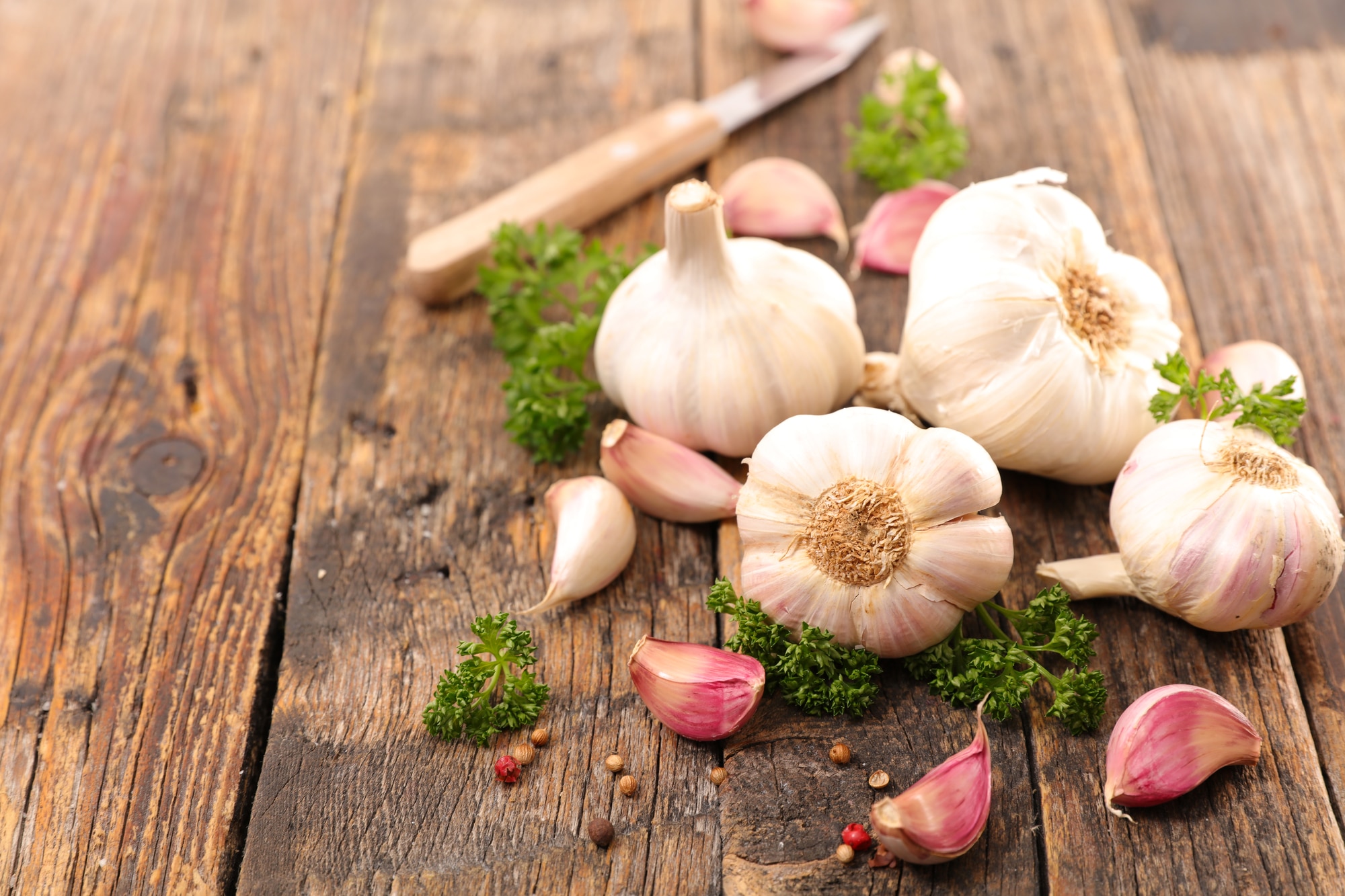 Cloves of garlic on a wooden table.