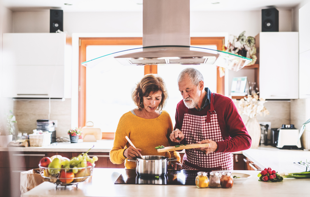 Senior couple preparing heart healthy foods in the kitchen.