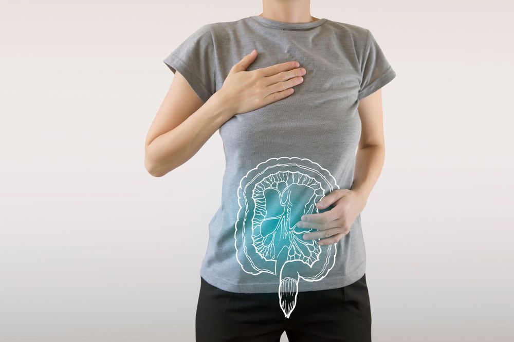 A woman with a digital composite of her intestines highlighted in blue.