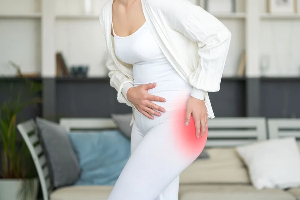 Woman with her hip pain highlighed in red.