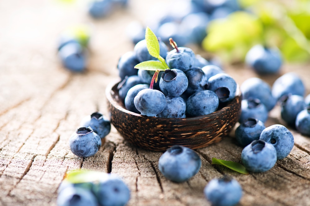 Fresh blueberries in a small wicker basket.