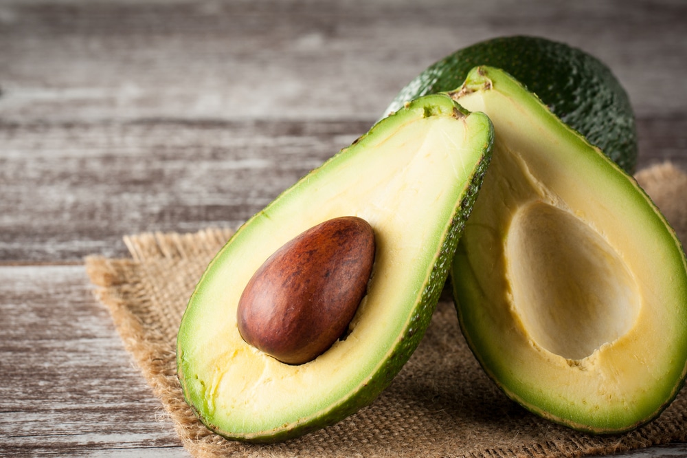 Close up of an avocado cut in half.