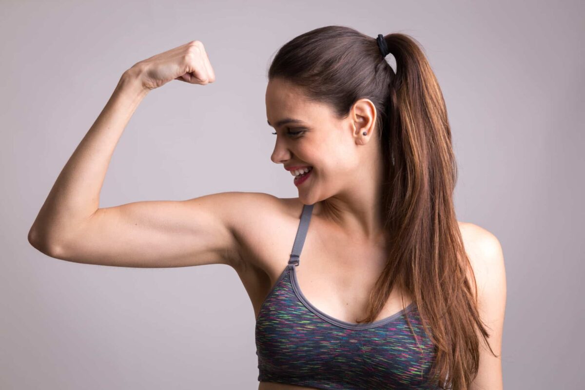 A woman flexing her bicep muscle.