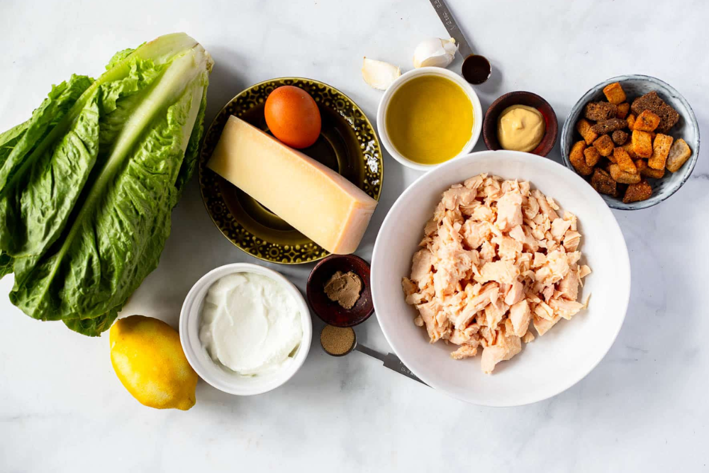 Top view of the ingredients for the viral chicken caesar salad pizza.