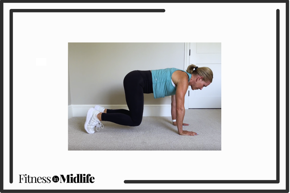 Chris Freytag doing a bear crawl hold exercise for lower abs.