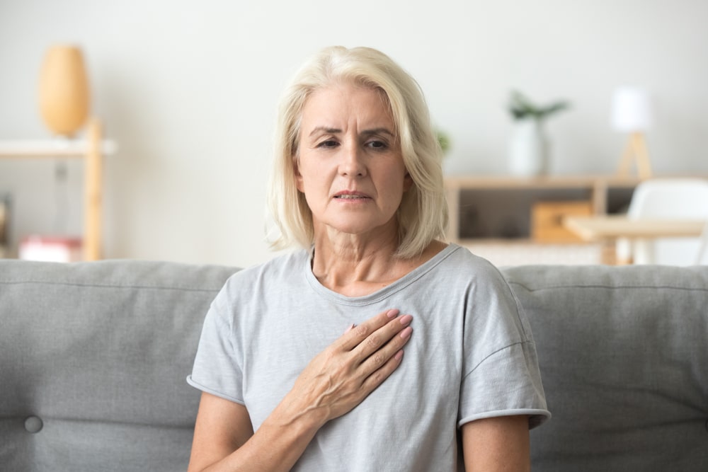 woman holding chest