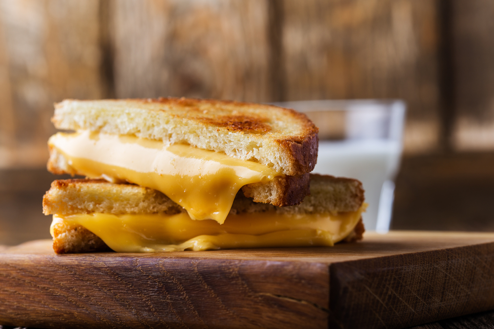 Two halves of a grilled cheese stacked on top of each other.