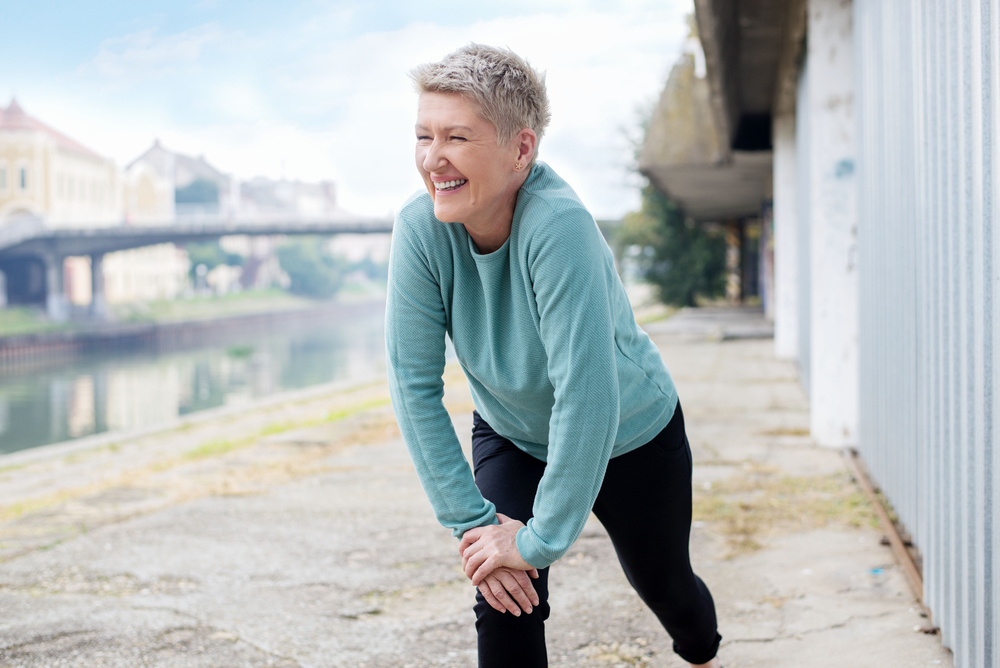 Older woman stretching before a functional strength training workout.