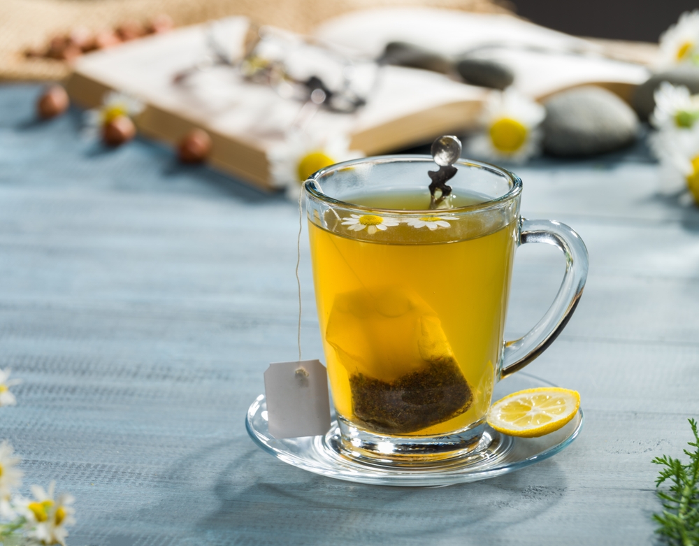 Chamomile tea in a glass mug.