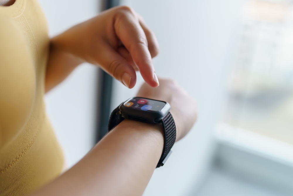 Woman looking at her fitness tracker watch.