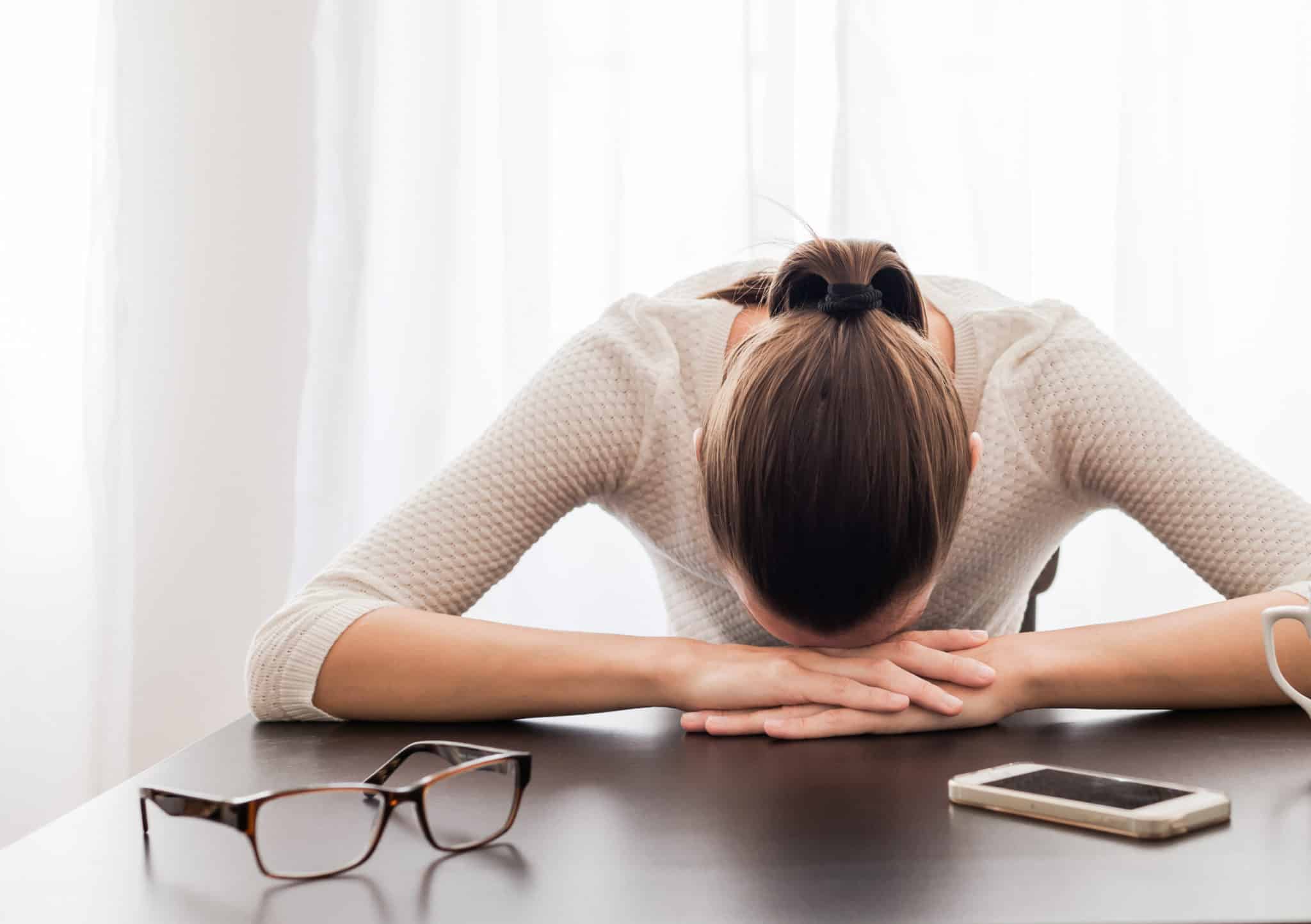 woman frustrated with head on table