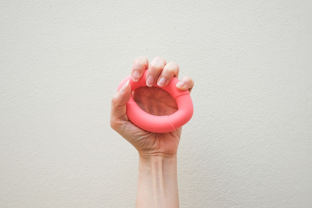 A woman's hand doing exercises for a weak grip.