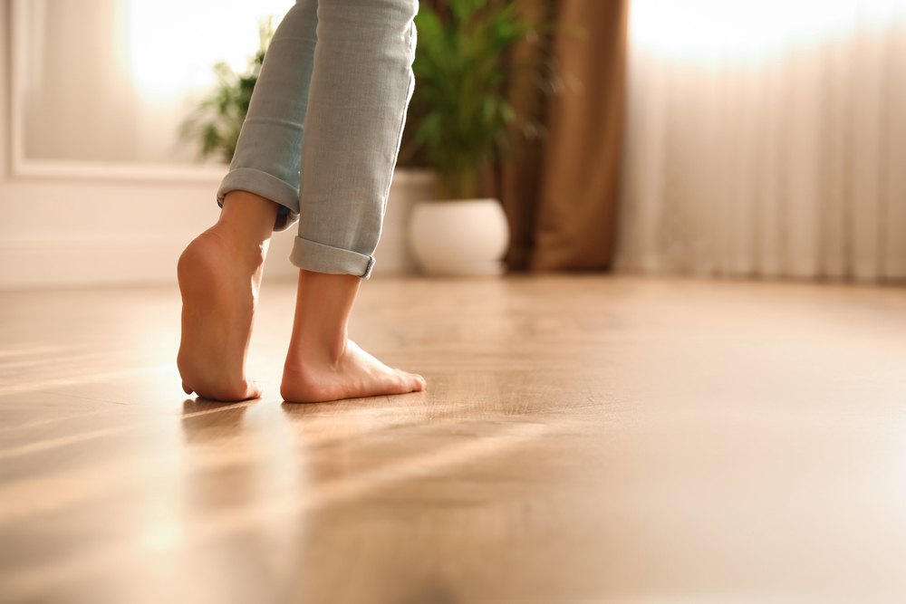 woman walking barefoot indoors