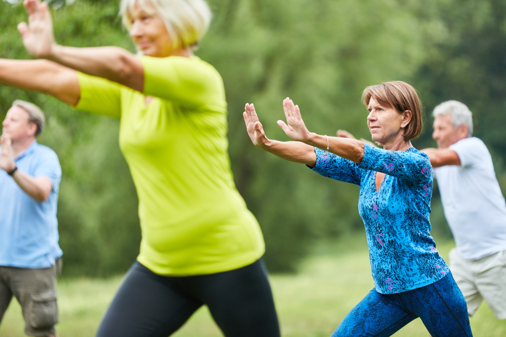 seniors doing tai chi outside