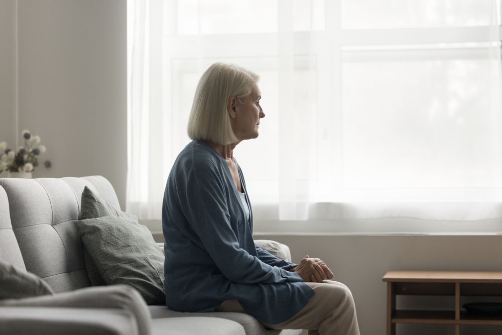 woman sitting on bed sad