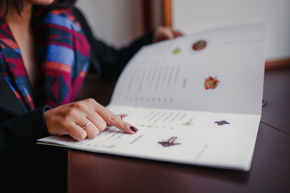 woman pointing at restaurant menu