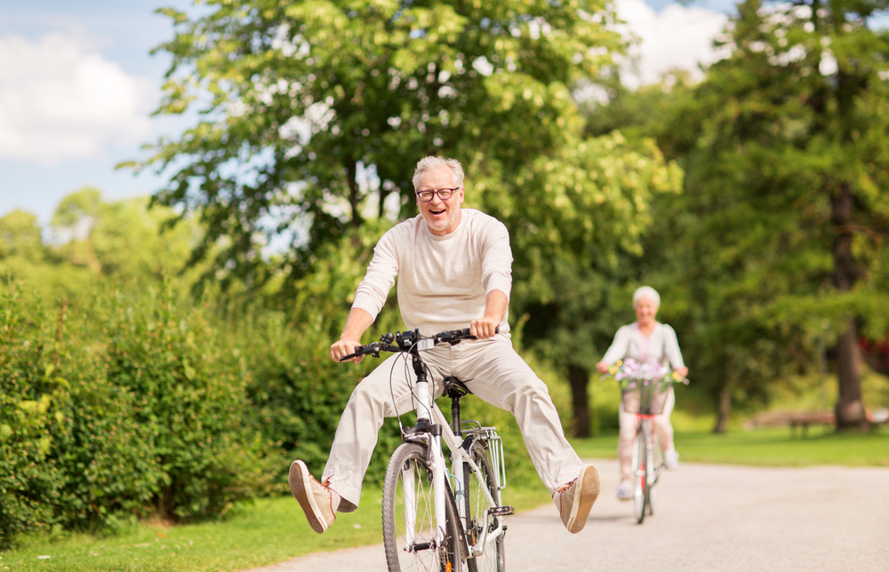 healthy aging people on bikes outside