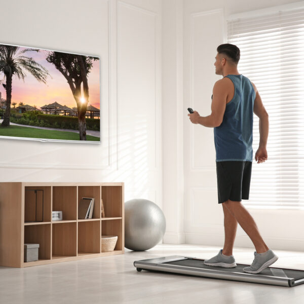 man using walking pad to stay healthy during winter