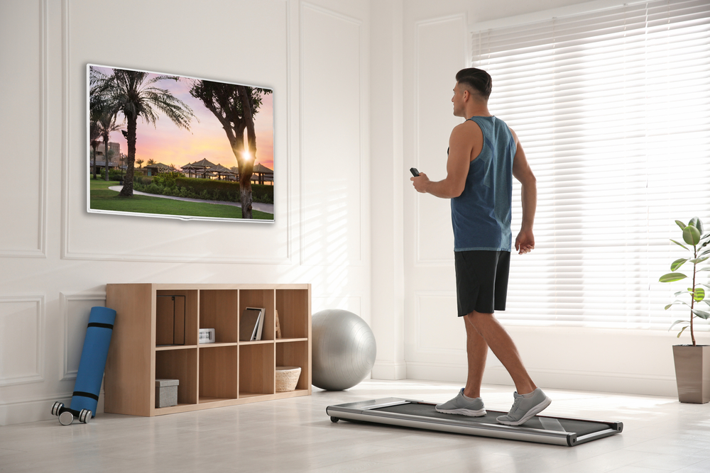 man using walking pad to stay healthy during winter